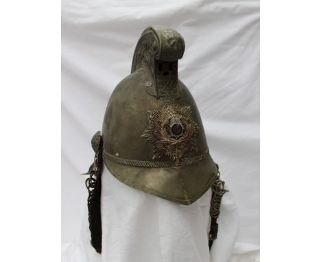 A Victorian white metal Merryweather pattern fireman's helmet, with dragon scroll crest and badge, fabric lined with chinstra