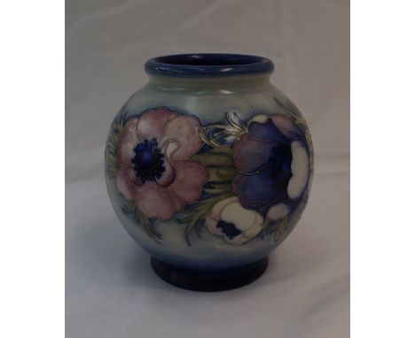 A Moorcroft pottery globe shape vase,  decorated in the anemone pattern with a graded light and dark blue ground, with blue a