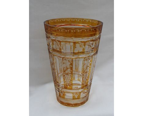 A 19th century continental amber flash glass vase of tapering cylindrical form decorated with flowers and leaves, 20cm high  