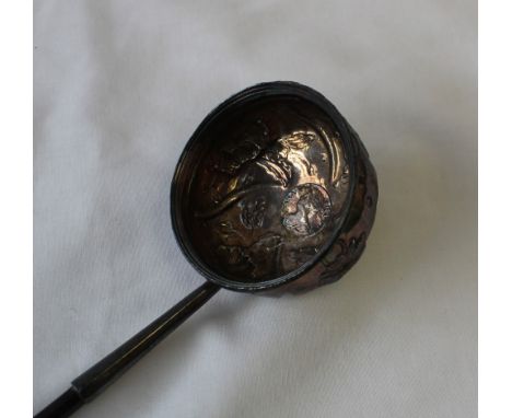 A white metal ladle with twisted handle, the bowl inset with a coin dated 1713