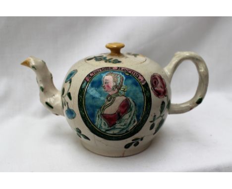 An 18th century salt glazed commemorative teapot, decorated with a portrait of "Charlotta Regina", with a rose and other flow
