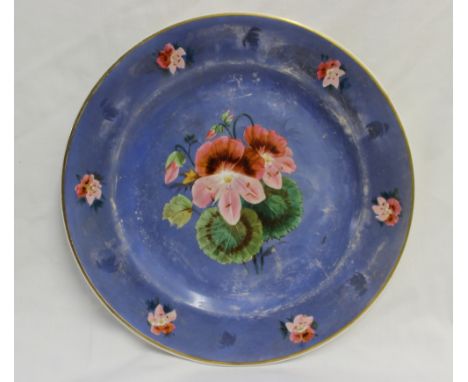 A porcelain plate, with a light blue ground, painted to the centre with flowers and leaves, the edge painted with flower head