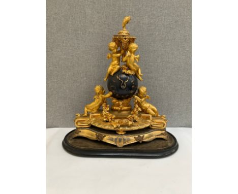 A French ormolu figural mantel clock of globe form with Olivant &amp; Botsford of Paris movement, highly ornate with cherubic