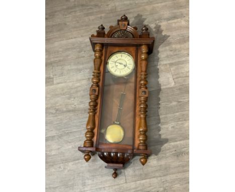 A Vienna walnut drop dial wall clock with Roman dial, spindle detail, decorative arch pediment, approx. 117cm tall x 45cm wid