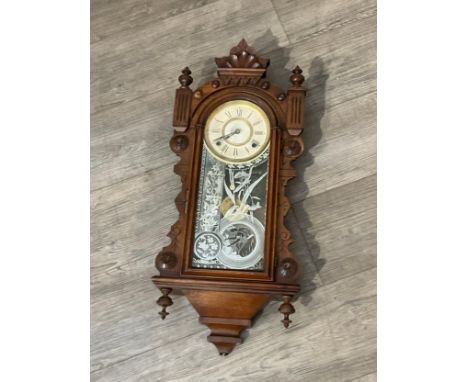 An Ansonia Clock Co. wall-hanging clock with compensation pendulum, 74cm tall x 30cm wide 