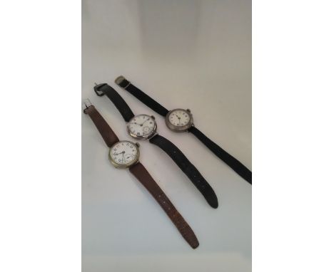 Three vintage silver cased gentleman's wristwatches in the trench style 