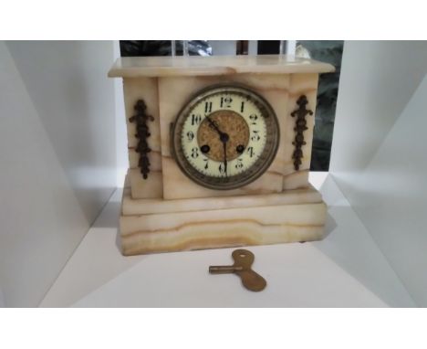 A circa 1900 onyx mantel clock with ceramic Arabic dial, brass centre, 19cm tall x 22.5cm wide, with key 