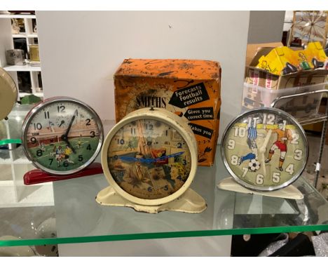 Three mid century football themed pictorial alarm clocks including Smiths Pools clock, boxed 
