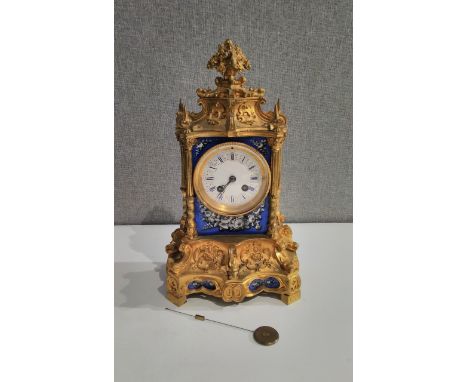 A late 19th Century French Ormolu and ceramic mantel clock, hand painted floral swags, two train movement, silk suspension, c