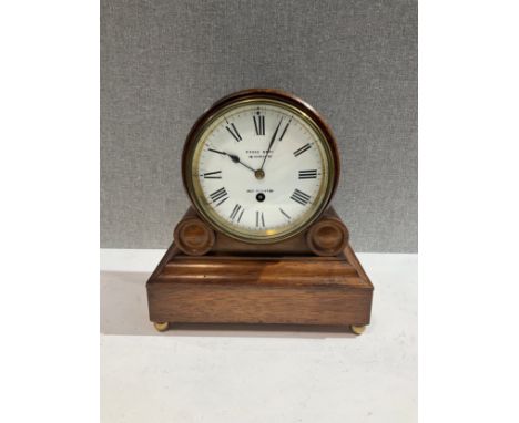 A Pooke Brothers of West Brighton mantel clock with Arabic enamel dial, oak barrel form case, raised on four brass feet, 26cm