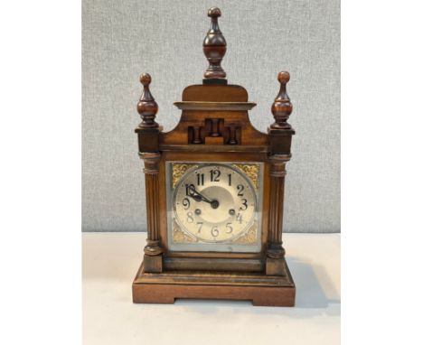 An early 20th Century walnut bracket clock, Arabic dial, gilt mounts, finial detail, with pendulum 