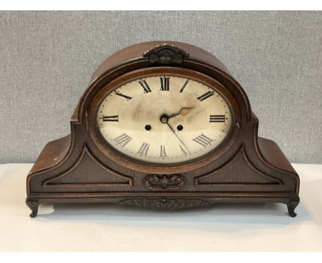 An Art Deco oak cased mantel clock of Napoleon hat form, oversized, Roman metallic dial, with pendulum 