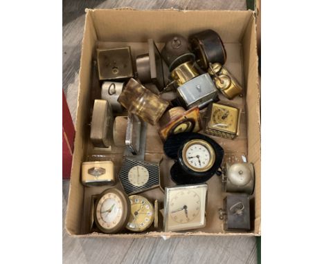 A box of mixed compact travel clocks 
