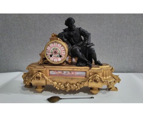 A 19th Century French ormolu mantel clock with painted ceramic face and panel, figural detail, with pendulum 