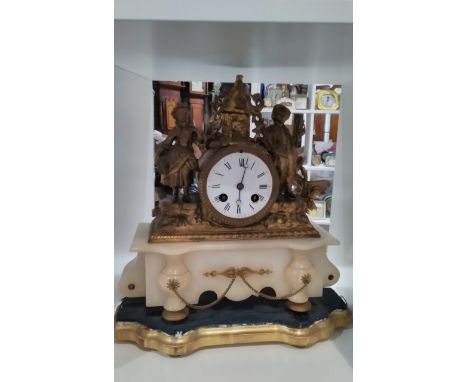 A French ormolu and alabaster mantel clock with figural and cottage design, face cracked 