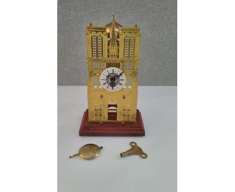 An ecclesiastical style cathedral design novelty mantel clock with key and pendulum 