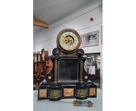 A late 19th Century black slate and marble mantel clock, Arabic porcelain chapter ring, visible escapement, 47cm tall, with p