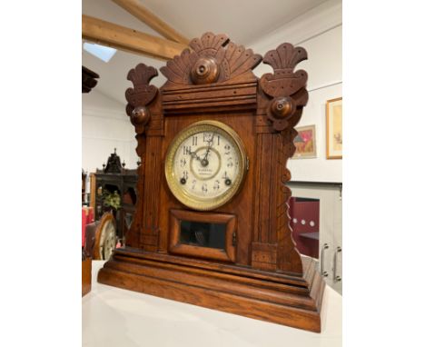 An early 20th Century Welch R. Greene of Norwich imported walnut cased mantel clock, fretwork detail, with pendulum 
