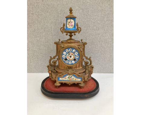 A 19th Century French ormolu mantel clock with hand painted ceramic face and panels, 36cm tall 