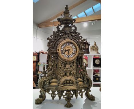 A 20th Century heavy cast brass mantel clock with scrolled detail 