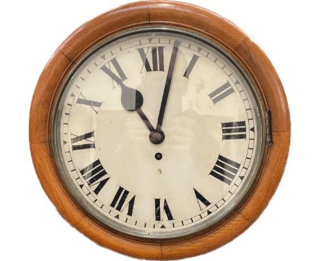 A circa 1900 oak cased dial clock with single fusee mechanism, Roman numerated painted face, case diameter 38cm, with pendulu