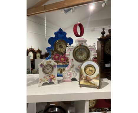 Four early 20th Century ceramic clocks, one of easel form 