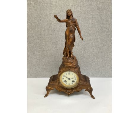 A French ormolu mantel clock surmounted by semi-clad female, 42cm tall 