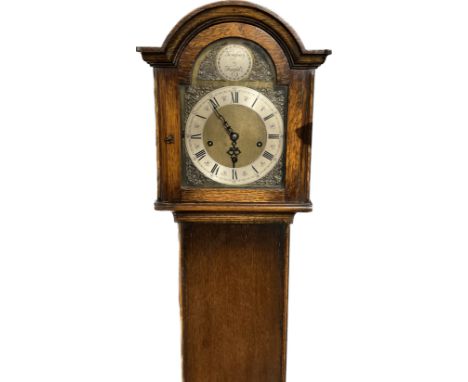 A 20th Century grandmother clock with Tempus Fugit detail, three train movement, striking on nine rods, oak cased, 167cm tall