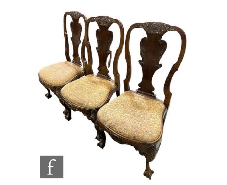 A set of three late 19th or early 20th Century Chippendale style mahogany dining chairs, the shaped scroll backs with scallop