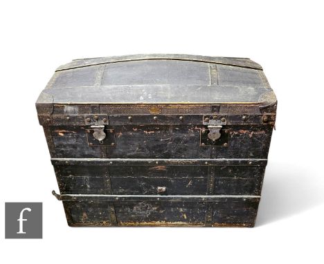 A late 19th and early 20th century part leather covered domed metal bound trunk.
