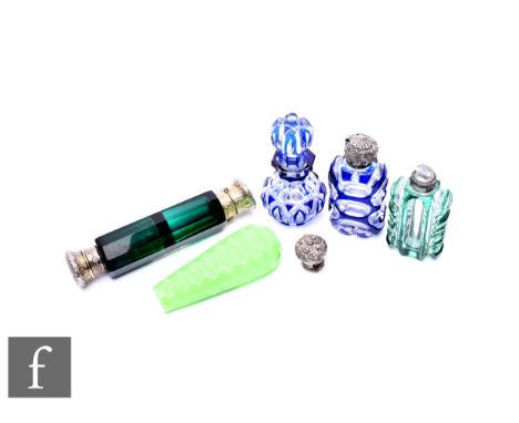 A Victorian emerald green facet cut double ended scent flask with foliate relief cast gilt metal mounts, lacking stoppers, le