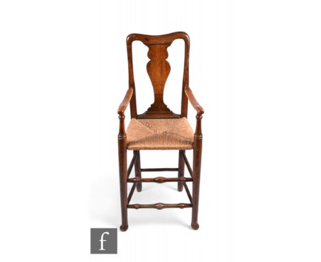 An 18th Century child's ash framed high chair, with vase shaped splat above the woven grass seat and turned bobbin stretchers