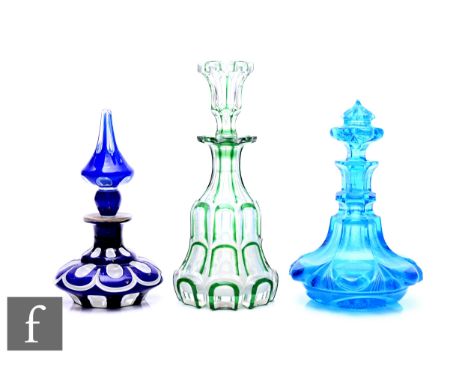 A late 19th Century Bohemian liqueur decanter, of mallet form with hollow blown mallet form stopper, cased in green with flas