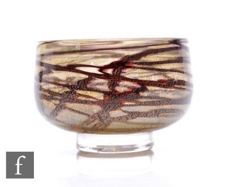An Allister Malcolm contemporary studio glass bowl, of footed inverted cylindrical form, trailed burnt umber over clear groun