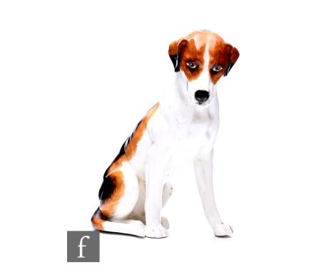 A Royal Worcester figure of a fox hound, unmarked, modelled sitting, with black, brown and white markings, height 17cm.