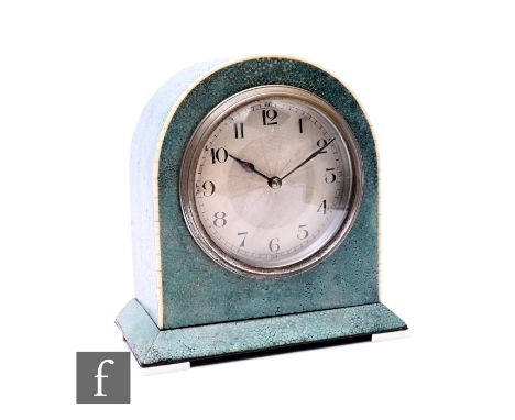 An Art Deco French shagreen and ivory veneered table or mantel clock of arched form, raised to an angular stepped base, with 