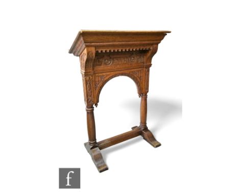 A Victorian carved oak lectern dated 1893, the slope over shaped brackets and pillared arch on a shaped trestle base, height 