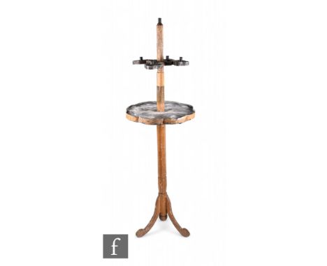 A rustic ecclesiastical five-light candlestick, with toleware drip tray below and raised to an octagonal painted support and 