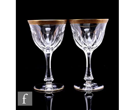 A pair of Moser 'Lady Hamilton' wine glasses, facet cut bowl with acid etched gilt rim, on facet cut stem and circular foot, 
