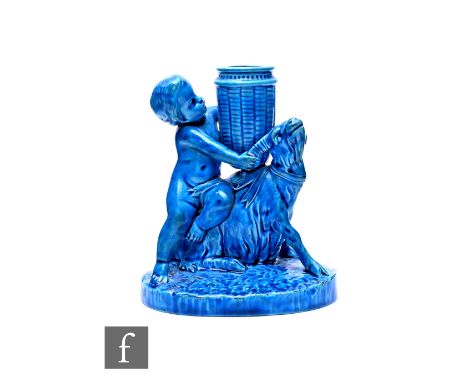 A Royal Worcester majolica blue glazed spill vase, circa 1880, modelled as a putti and goat with grape basket, oval naturalis