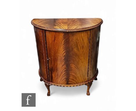 A Chippendale style mahogany demi lune side cabinet on claw and ball feet below a gadrooned edge, height 97cm x depth 47cm x 