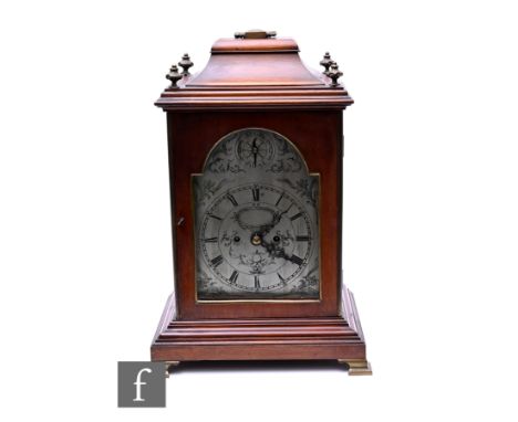 A late 19th Century George III style mahogany cased bracket clock, the engraved silvered arch dial enclosed by a glazed door,