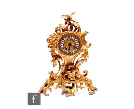 A 19th Century French gilt mantle clock, circular enamelled dial, the acanthus case mounted with two feeding birds on pierced