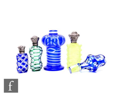 A collection of late 19th Century glass scent flasks, including flashed green example, lens cut and with metal mounts and hin