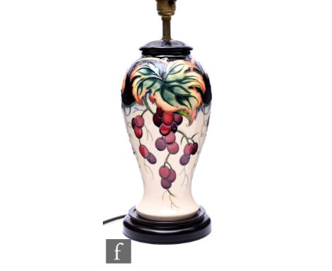 Philip Gibson for Moorcroft pottery, a Provence pattern table lamp, circa 2005, of inverse baluster form, tubeline decorated 