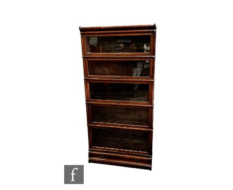 A 1920s oak Globe Wernicke five tier sectional bookcase over a base drawer, height 178cm x depth 31cm x width 86cm.