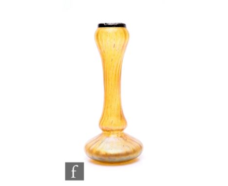 An early 20th Century Kralik glass iridescent amber glass vase, of flattened spherical form with high drawn baluster form nec