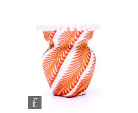 A late 19th Century opaque opal glass vase, of lobed form with everted ruffled matt glass rim, the body with feathered mustar