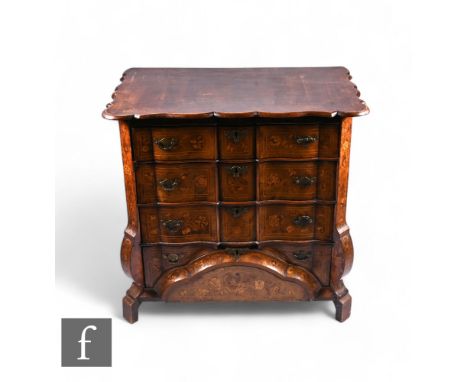 An 18th Century Dutch marquetry inlaid chest of four long graduated drawers, the crossbanded undulating top over a floral mar
