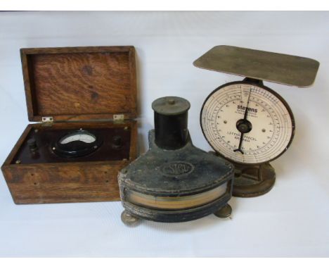 A vintage postal scale, scientific instrument and voltmeter.